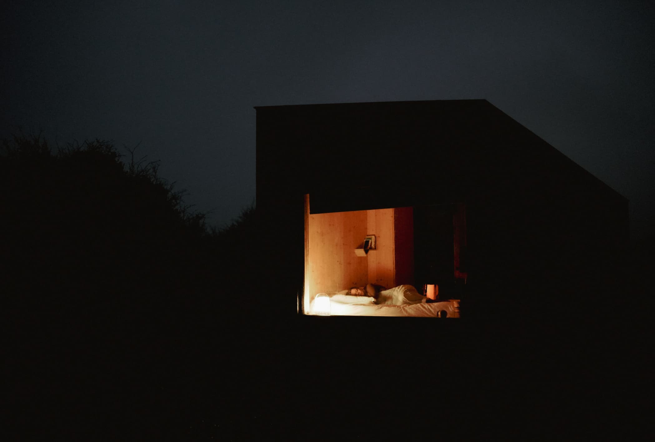 woman sleeping in a cabin at night