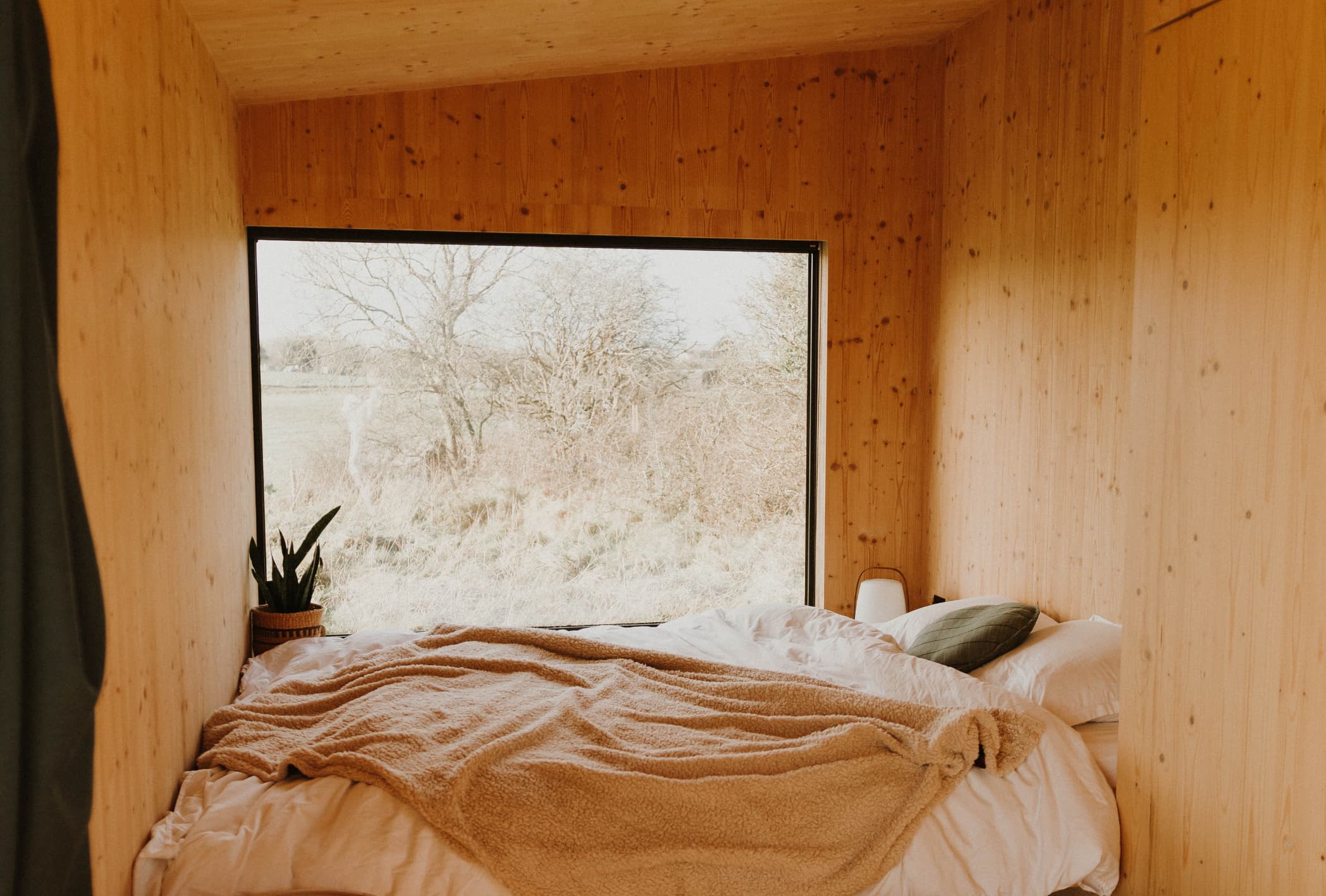 bed by a window in a cabin